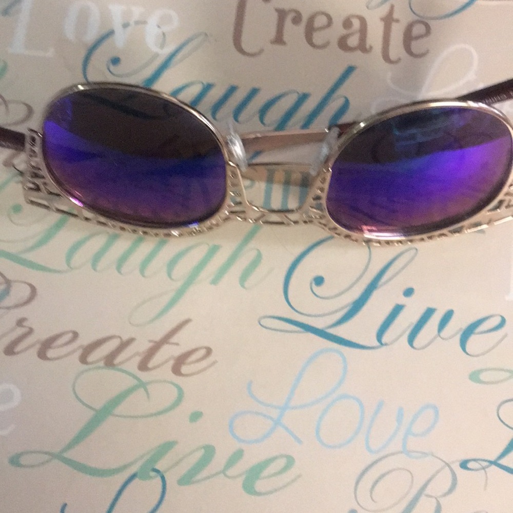 Gold Sunglasses with details around the frame.